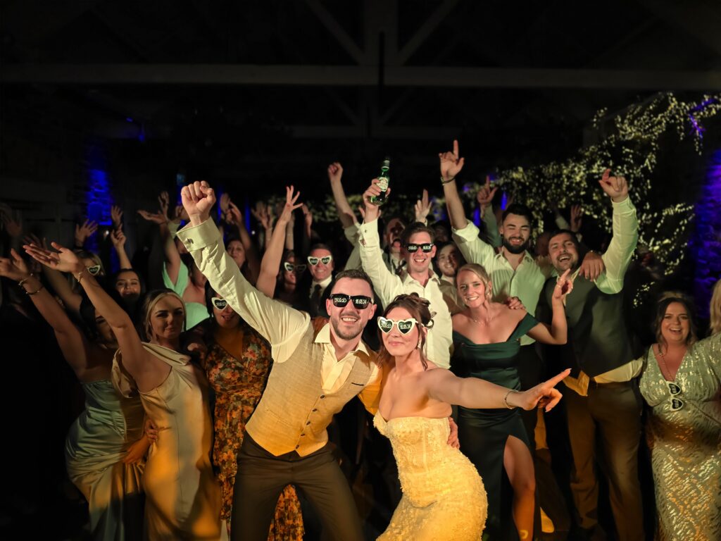 A group having a wedding party and posing for a photo