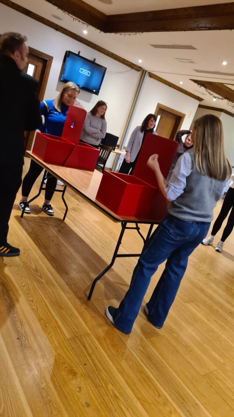 A group participating in "The Cube", a popular group activity for a hen party, wedding, stag party, corporate events, birthday parties, and more.