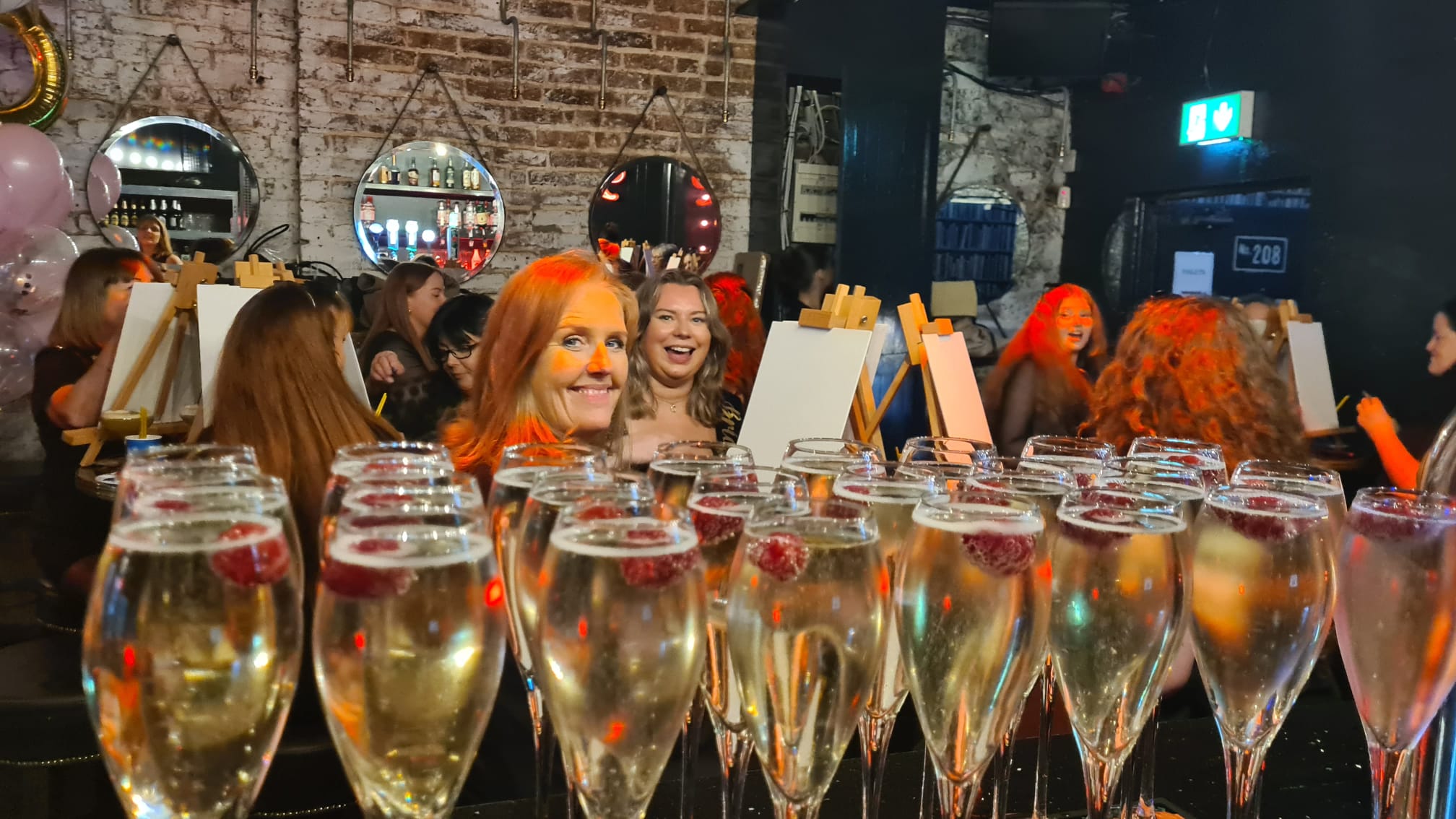 A group participating in "Paint and Prosecco", which is a group activity for a hen party, wedding, or a birthday party.